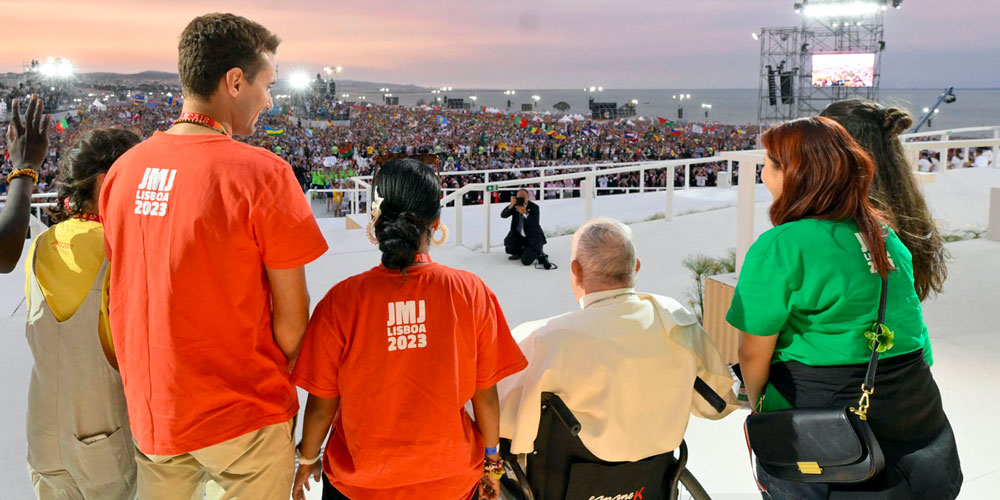 The Pope looks out to the gathered pilgrims as the sun sets on the WYD vigil